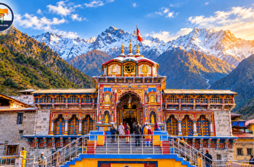 Badrinath Dham Temple in Uttarakhand surrounded by snow-covered Himalayan mountains at golden hour, with pilgrims visiting the colourful temple and Maharashtra Views logo in the top-left corner.
