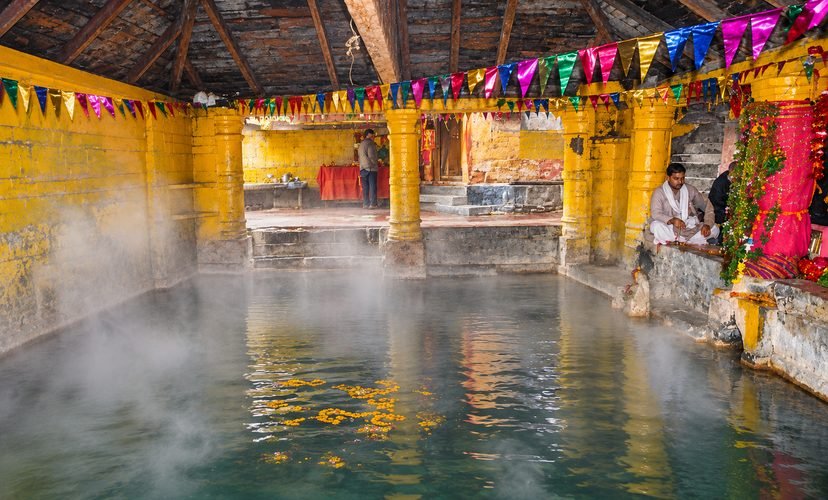 Pilgrims dipping rice potali in Surya Kund hot spring at Yamunotri Dham

